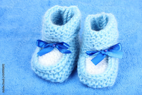 bright baby booties on blue background