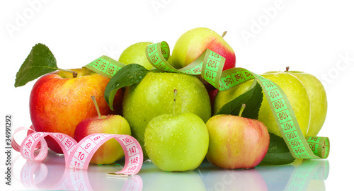Concept of diet. Many fresh ripe apples with measuring tape