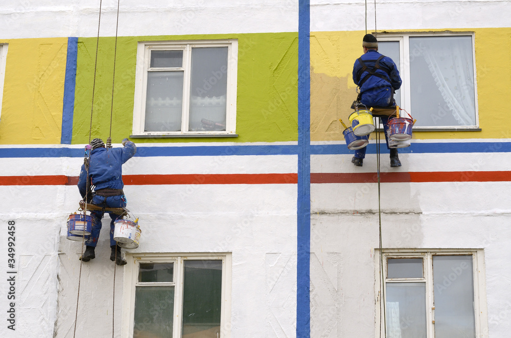 House painters paint the facade of building House painters paint the facade of building