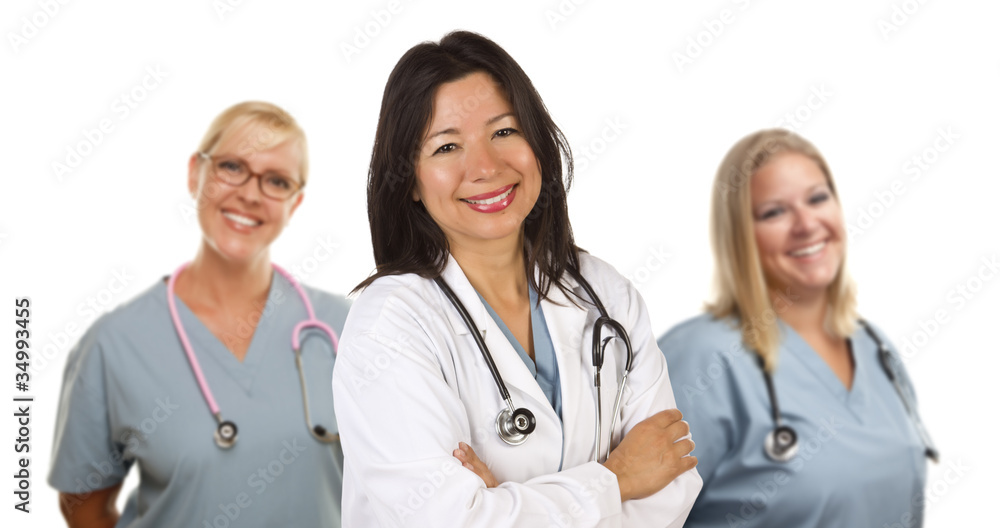 Hispanic Female Doctor and Colleagues Behind Hispanic Female Doctor and Colleagues Behind
