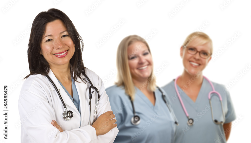 Hispanic Female Doctor and Colleagues Behind Hispanic Female Doctor and Colleagues Behind