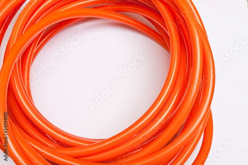 Orange garden hose coiled