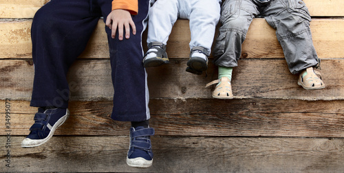 three boy on wood deck