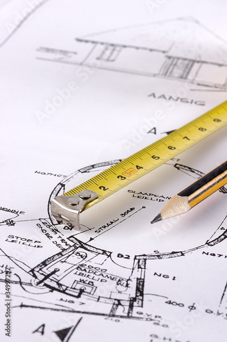 Measuring tape and pencil on a technical drawing