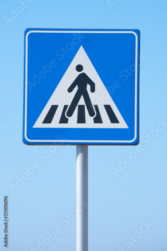 crossing sign on blue sky background