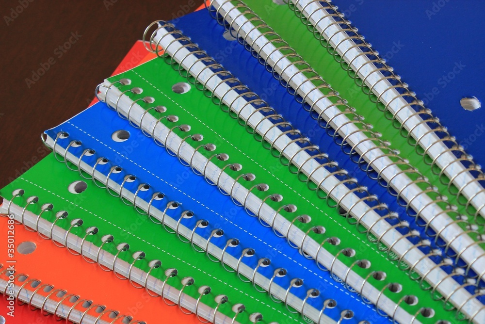 An array of colorful compostion books