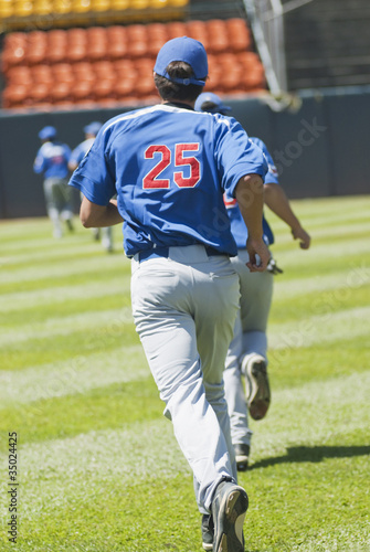 Hispanic baseball player running on field photo
