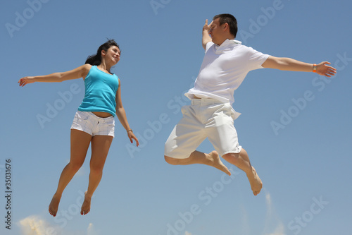 Young man and woman jumping