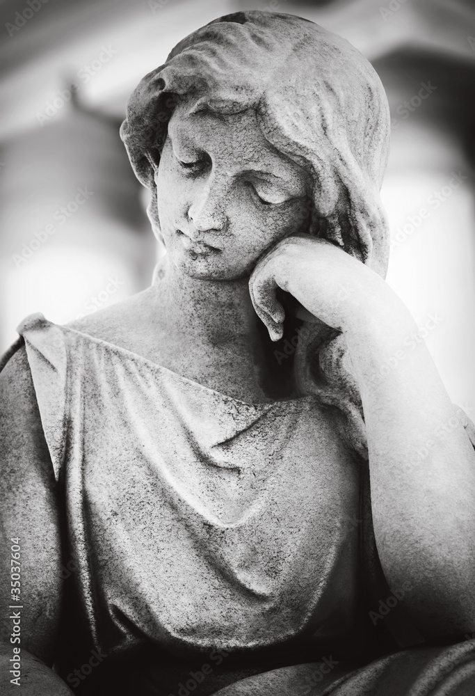 Weathered statue of a beautiful young woman