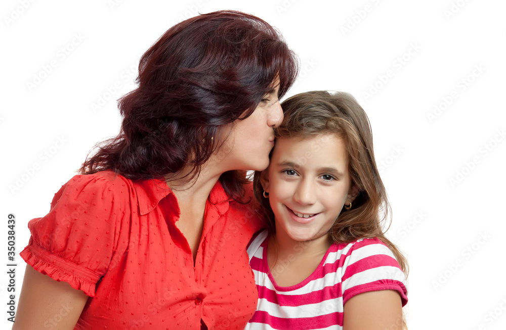 Latin mother kissing her daughter on a white background Latin mother kissing her daughter on a white background