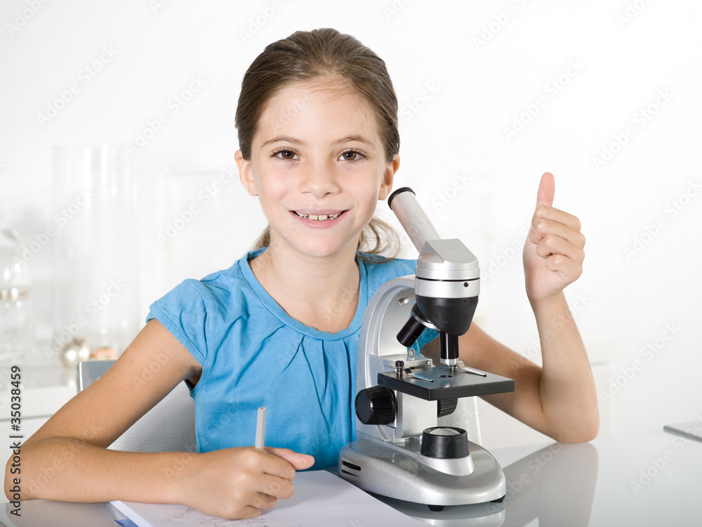 little girl  study with microscope