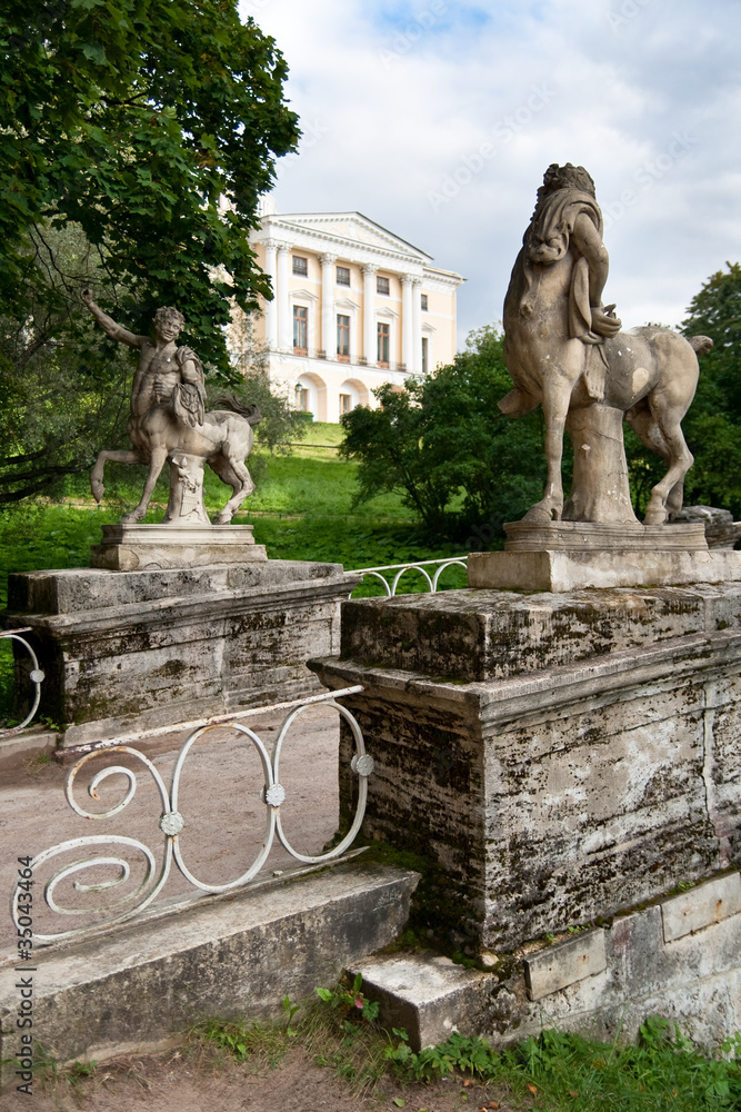 The statues on the bridge and view of the palace