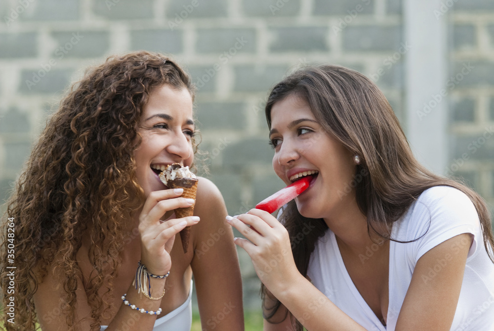 Hispanic friends eating ice cream together Hispanic friends eating ice cream together