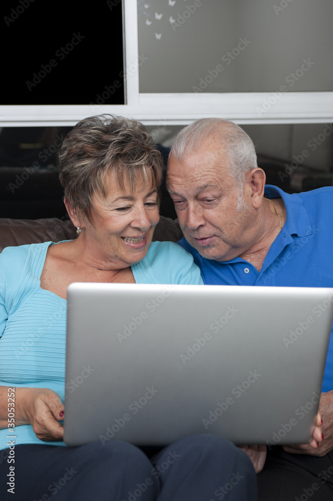 Senior Hispanic couple looking at laptop Senior Hispanic couple looking at laptop
