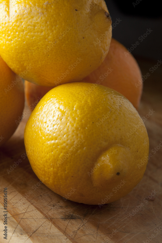 Lemon on wooden chopping board, ready for preparation to eat.. Lemon on wooden chopping board, ready for preparation to eat..
