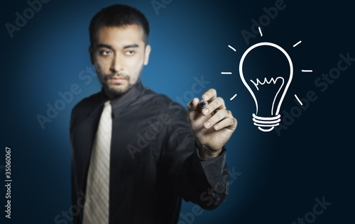 business man drawing light bulb