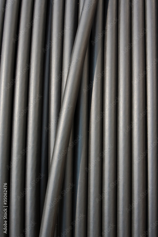Close-up of black electricity cable vertical on a spool. Close-up of black electricity cable vertical on a spool.