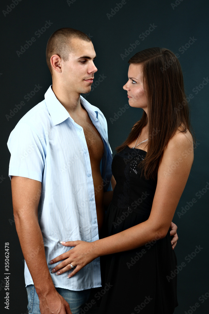 Fototapeta premium Young man with undone shirt and his girlfriend