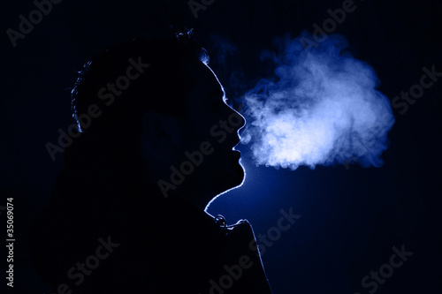 Man exhaling warm breath photo