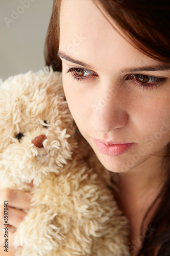 Close up teenage girl with cuddly toy photo