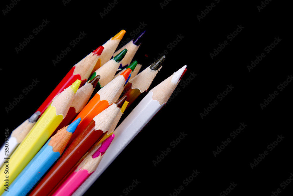 Assortment of coloured pencils with shadow on white/back backgro Assortment of coloured pencils with shadow on white/back backgro