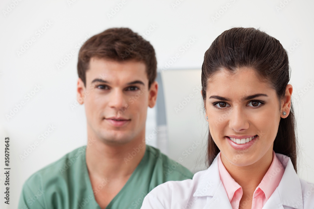 Female doctor with colleague standing behind Female doctor with colleague standing behind