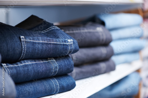 jeans clothes on shelf in shop photo