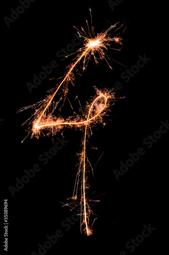 Digit 4 made of sparklers isolated on black