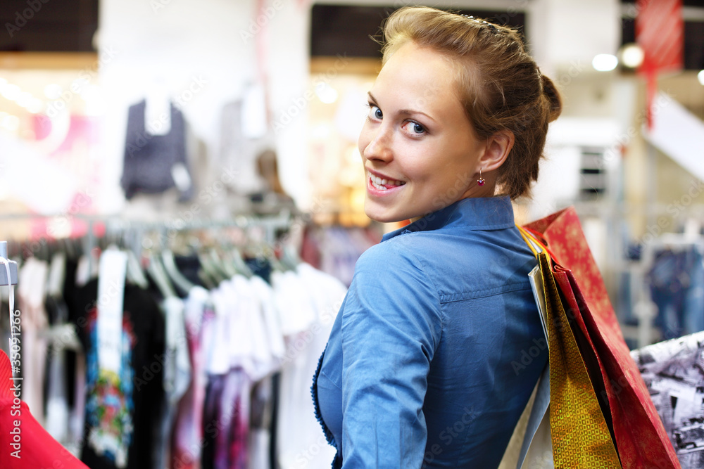 Woman in a shop buying clothes Woman in a shop buying clothes