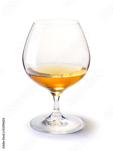 cognac glass with gold cognac on a white with shadow