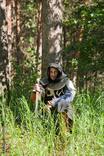 Knight sitting  in  forest