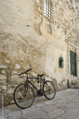 A bicycle parcked by church ruins