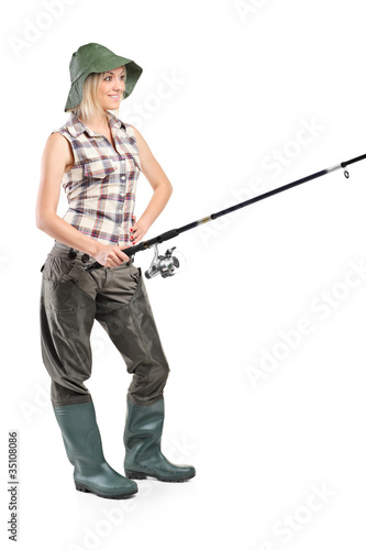 Full length portrait of a woman holding a fishing pole