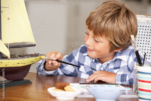 Young boy making model ship