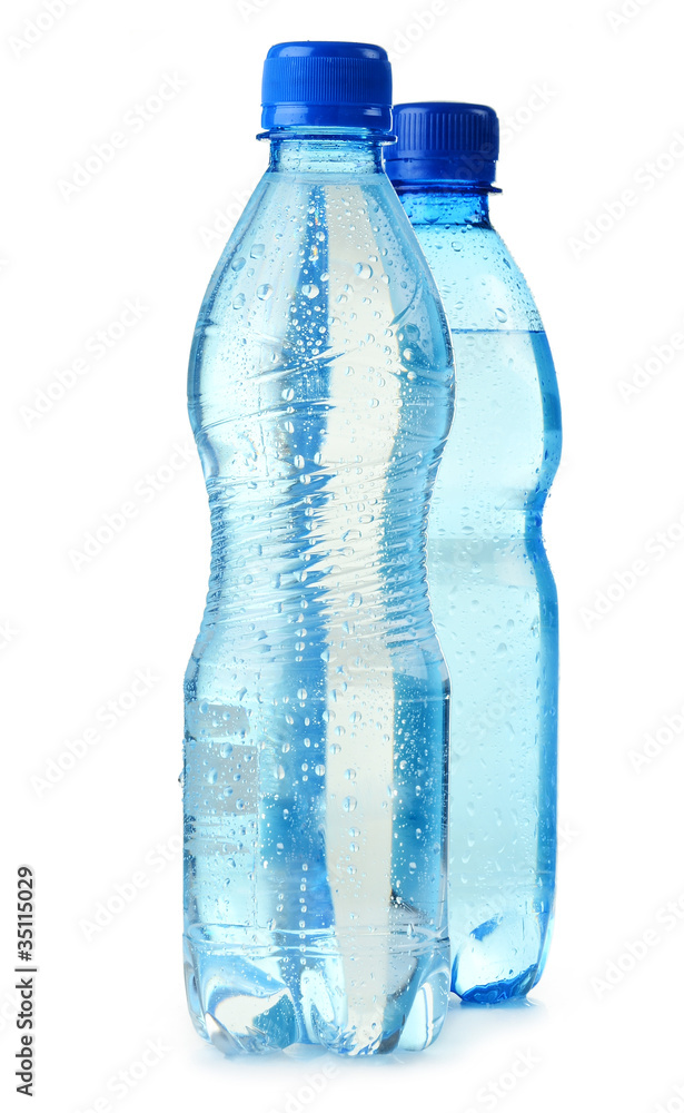 Polycarbonate plastic bottles of mineral water isolated on white Polycarbonate plastic bottles of mineral water isolated on white