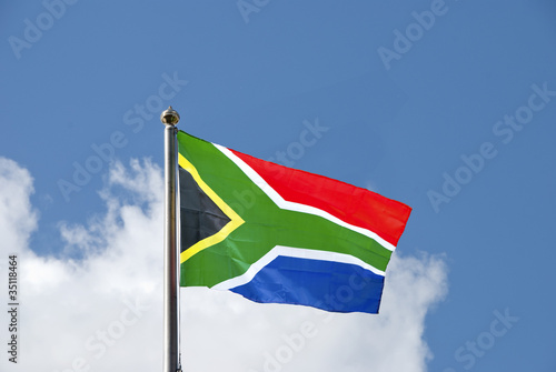 South African Flag on a flagpole against a blue sky