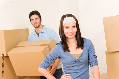 Moving home young couple carrying cardboard boxes © CandyBox Images