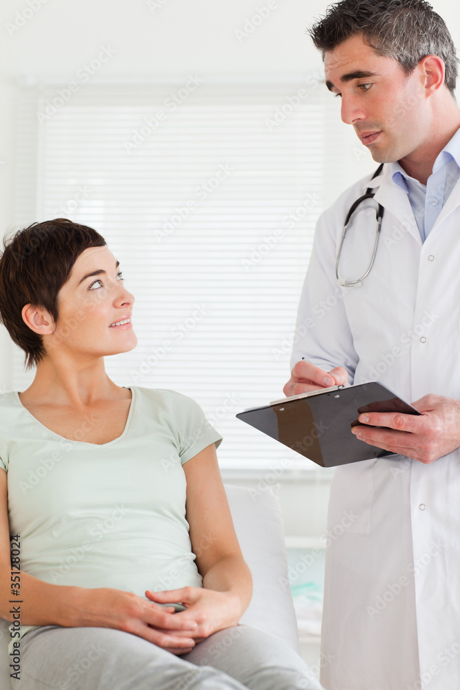 Male Doctor and female patient looking at each other Male Doctor and female patient looking at each other