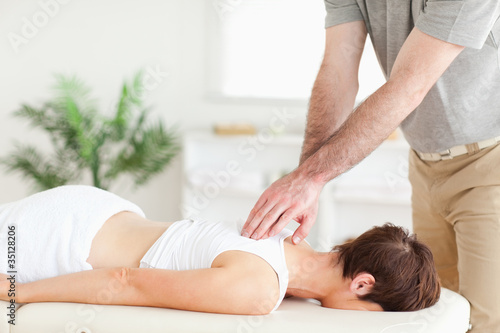 Masseur massaging a female customer's back