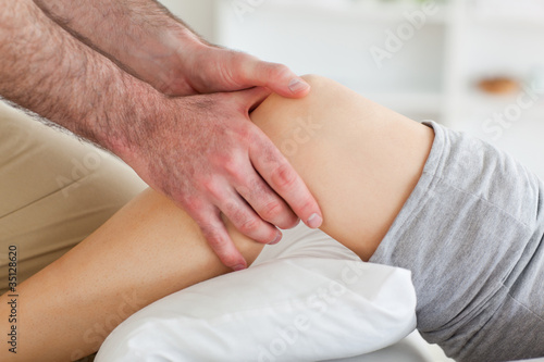 Man massaging a woman's knee