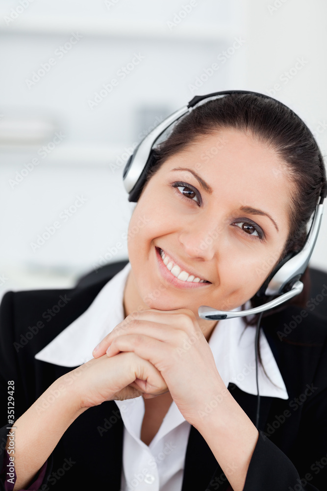 Smiling operator with headset in her office Smiling operator with headset in her office