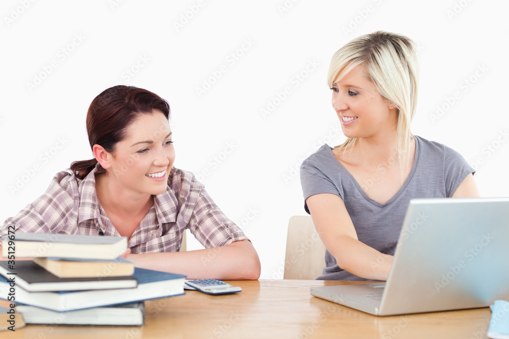 Pretty women learning with laptop and books Pretty women learning with laptop and books