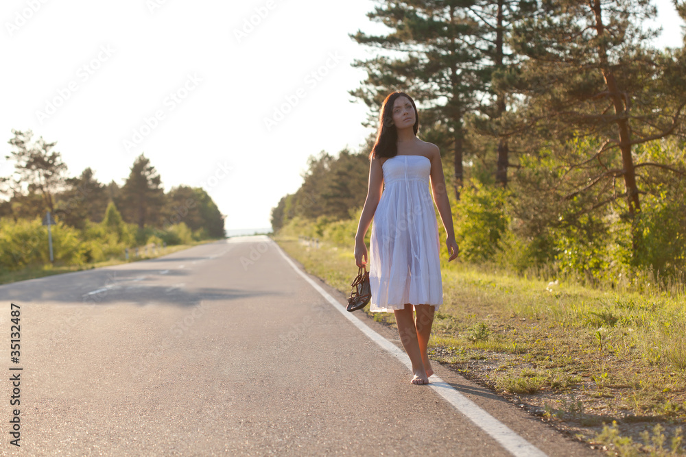 woman walking along the road
