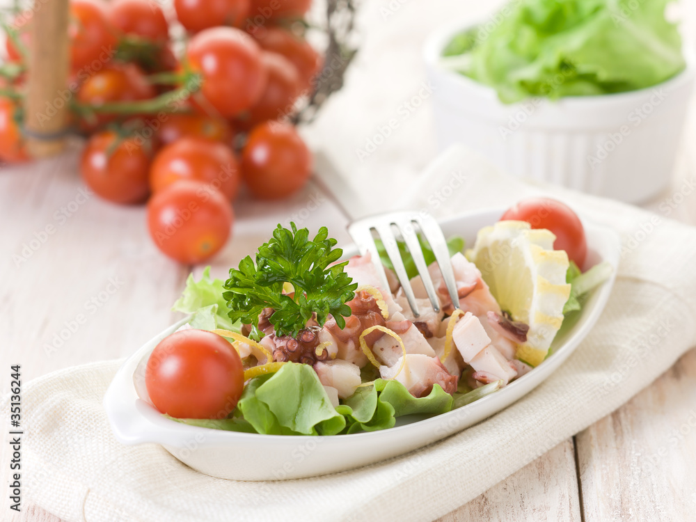 octopus salad with tomatoes and lettuce