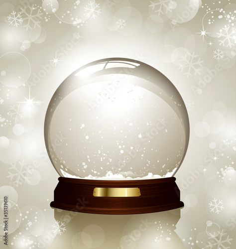 empty snowglobe against a bright defocused background photo