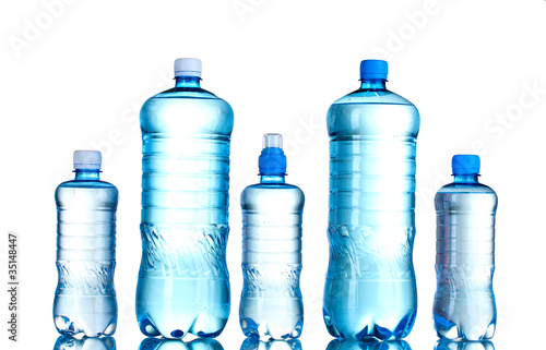 Group plastic bottles of water isolated on white