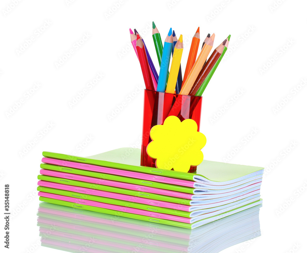 Fototapeta premium Bright pencils in red holder and notebooks isolated on white