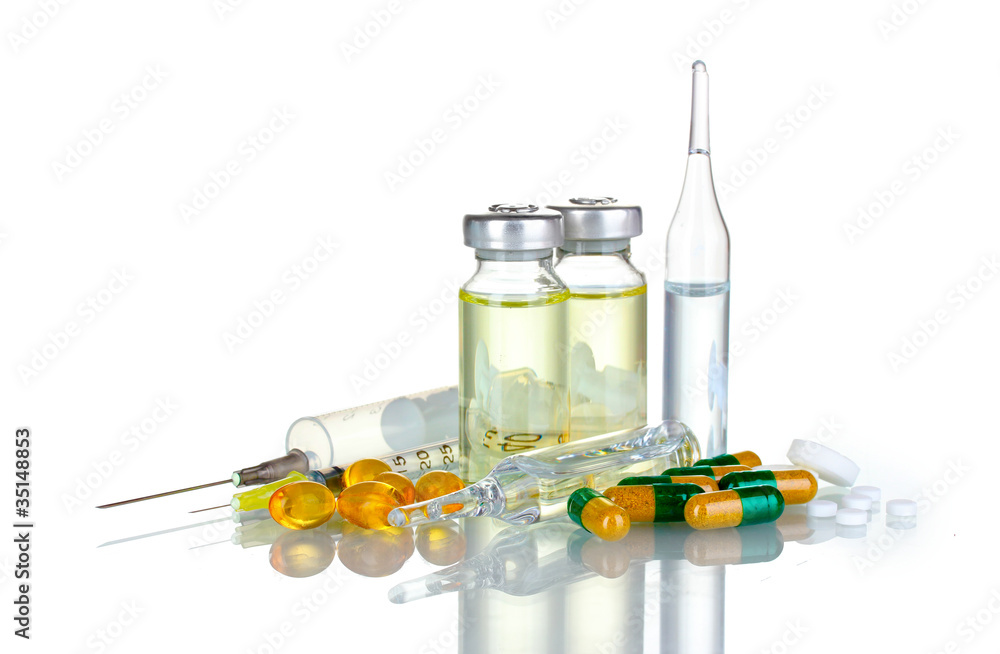 Medical ampoules, syringe and pills isolated on white Medical ampoules, syringe and pills isolated on white