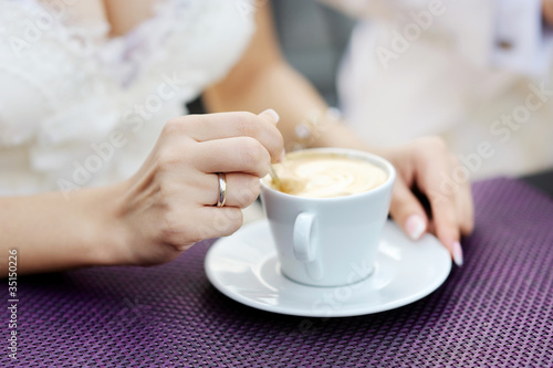 Bride drinking coffee at a wedding day