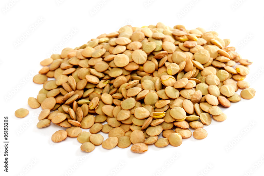 Brown lentils scattered on white background Brown lentils scattered on white background